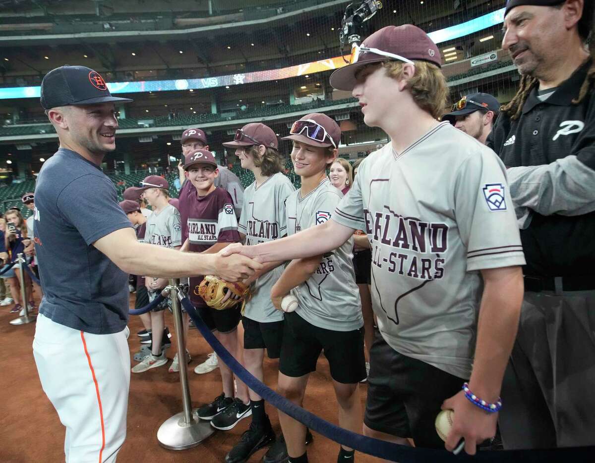 The Pearland Little Leaguers, who are headed to the Little League World Series, meet Houston Astros third baseman Alex Bregman during batting practice before the start of an MLB game at Minute Maid Park on Wednesday, Aug. 10, 2022 in Houston.