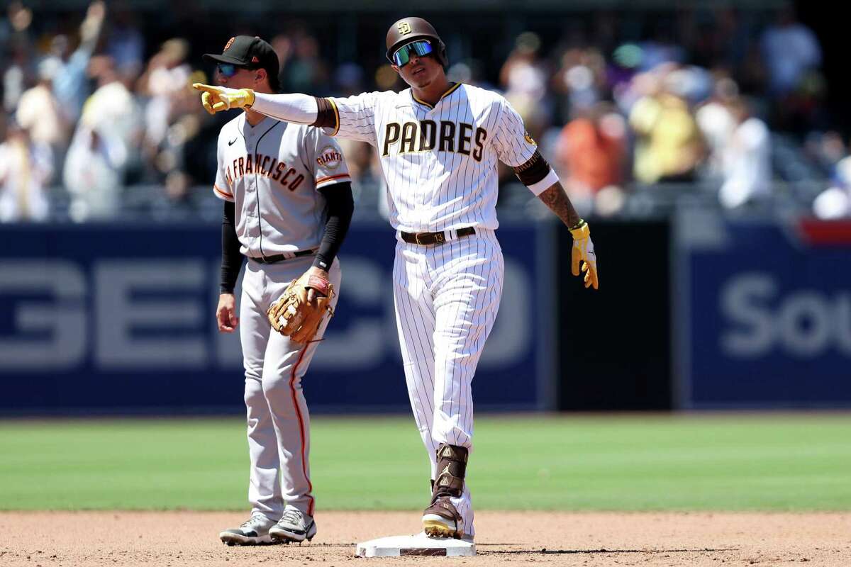 Manny Machado of the San Diego Padres celebrates after hitting an