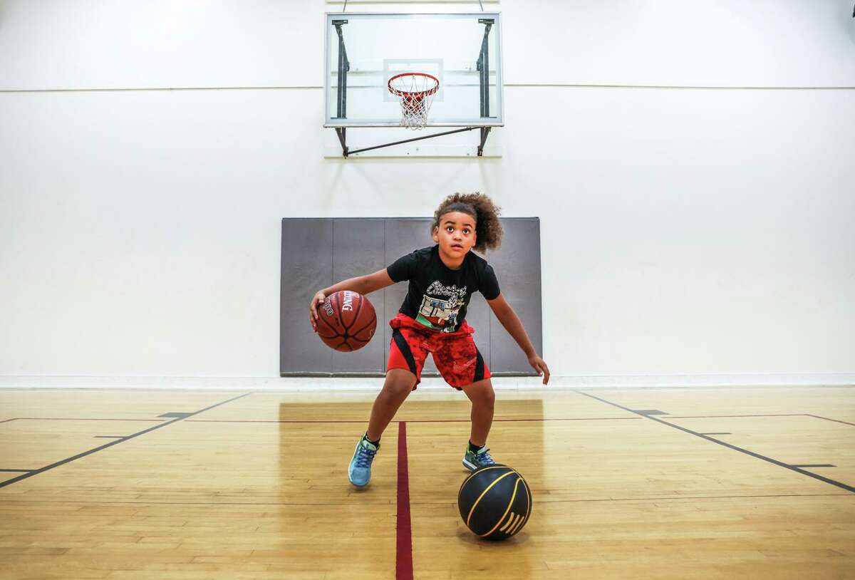 Elite basketball player King Tari Johnson, 8, dribbles during a practice session in Lodi (San Joaquin County). King Tari is the eighth-ranked 8-year-old basketball player in the nation.