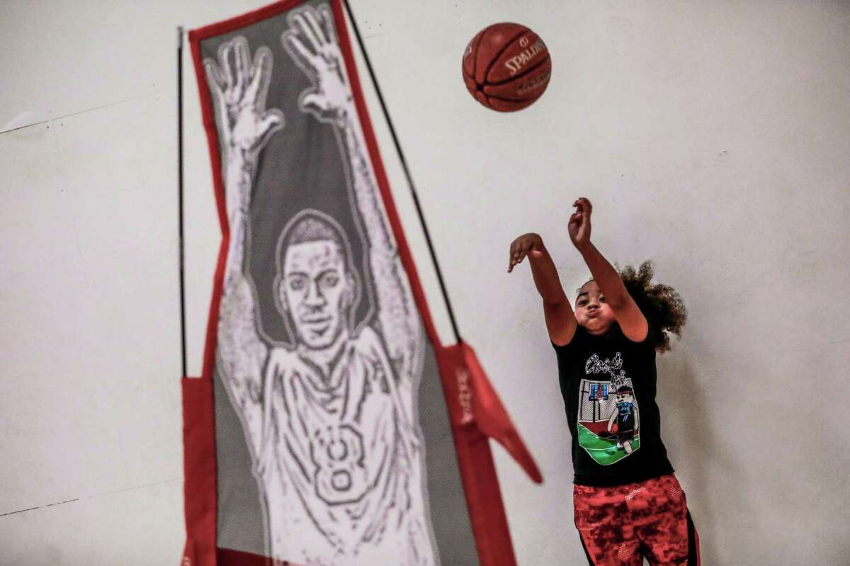King Tari Johnson, 8, takes a shot during a practice session at a gym in Lodi.