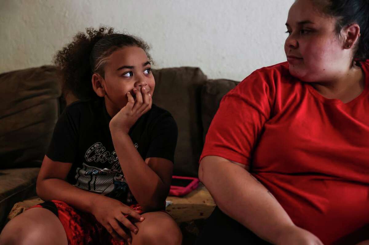 King Tari Johnson, 8 (left), with his mom, Felicia Wood, in their home in Stockton.