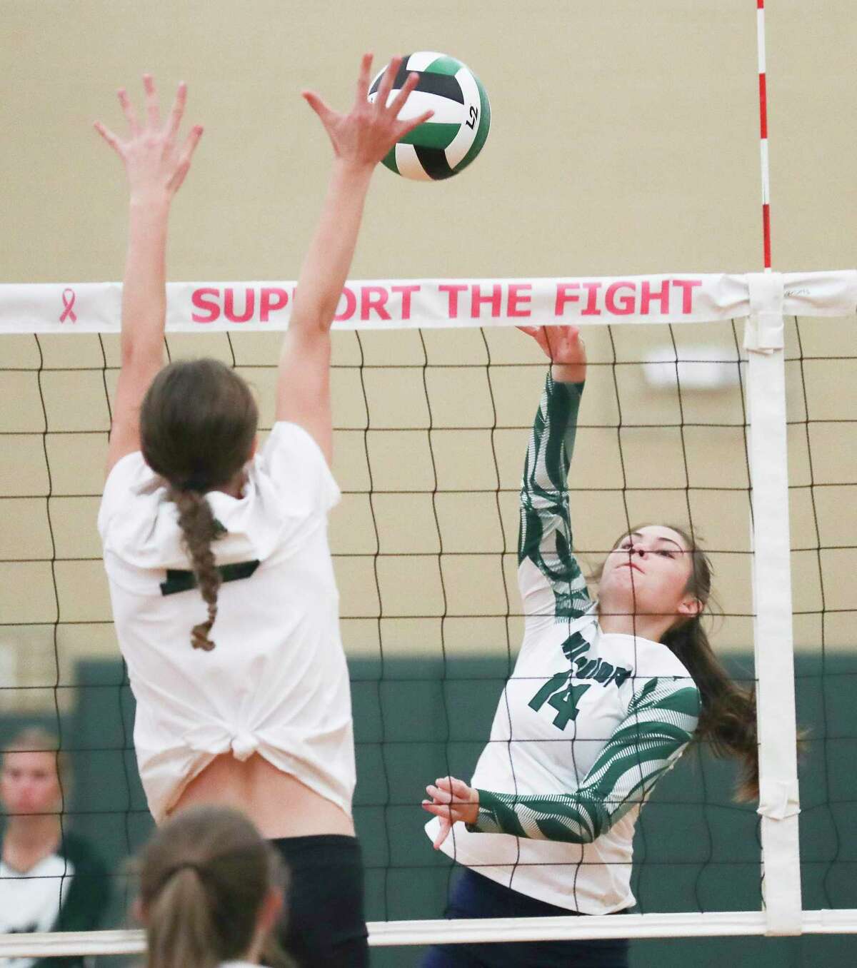 The Woodlands Christian Academy's Jordan Booth (14) gets a shot off in the first set of a non-district high school volleyball match at The John Cooper School, Wednesday, Aug. 10, 2022, in The Woodlands.