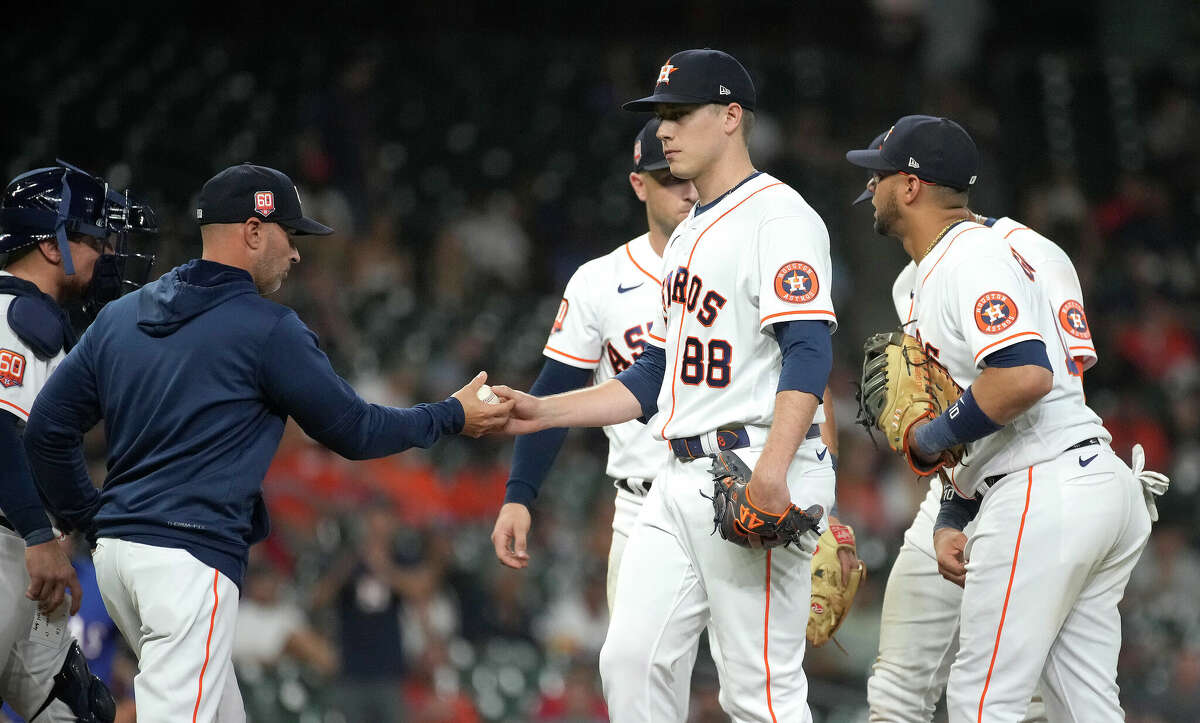 Houston Astros relief pitcher Phil Maton (88) is pulled by acting manager Joe Espada after Texas Rangers Adolis Garciaâs single during the tenth inning of an MLB game at Minute Maid Park on Wednesday, Aug. 10, 2022 in Houston.