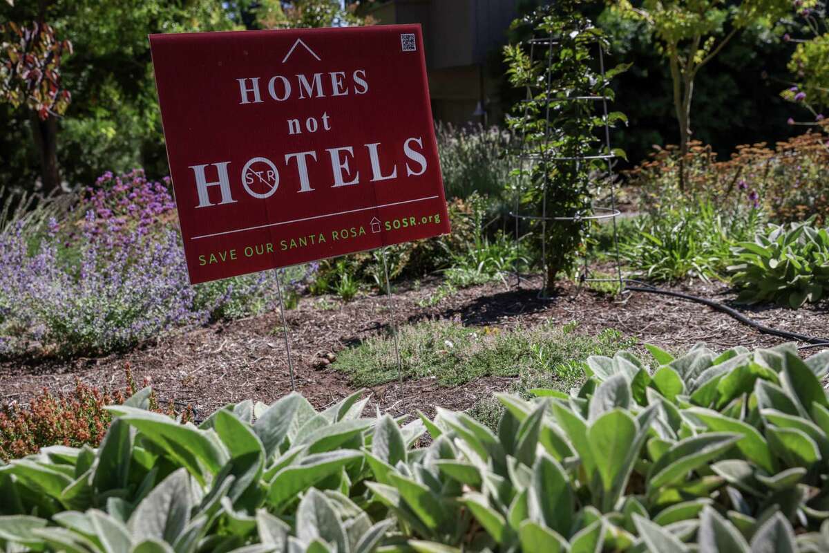 A sign decrying short-term rentals is posted at the home of Maureen Linde in Santa Rosa. Linde said a house nearby has become increasingly noisy after it became a short-term rental.