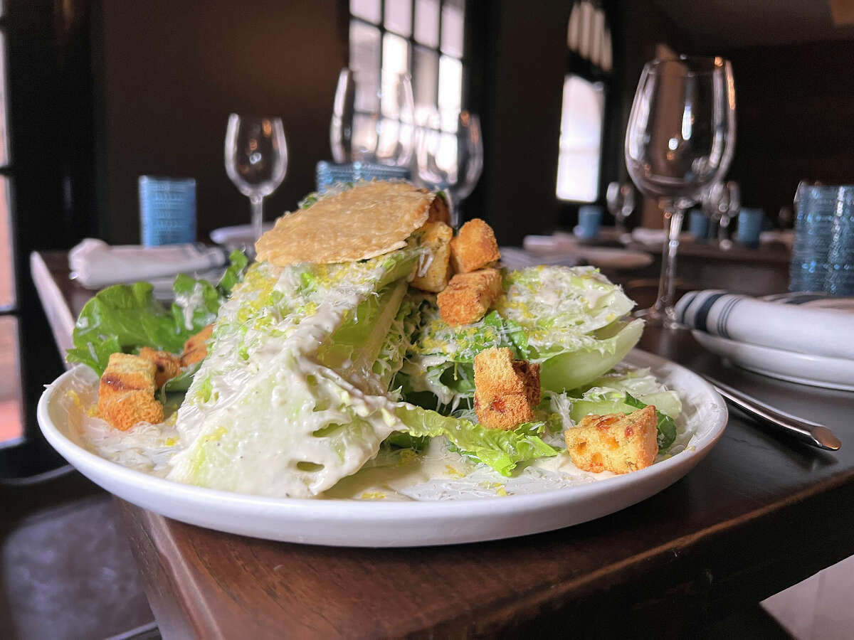 Caesar salad includes cornbread croutons, a cheese crisp and cured egg yolk at Lazo with Don Strange, the restaurant at the Estancia del Norte hotel in San Antonio. 