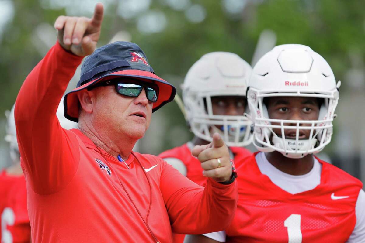 Atascocita head coach Craig Stump, left, talks with quarterback Zion Brown, right, during a high school football practice at the campus facilities Tuesday, Aug. 9, 2022 in Humble, TX.