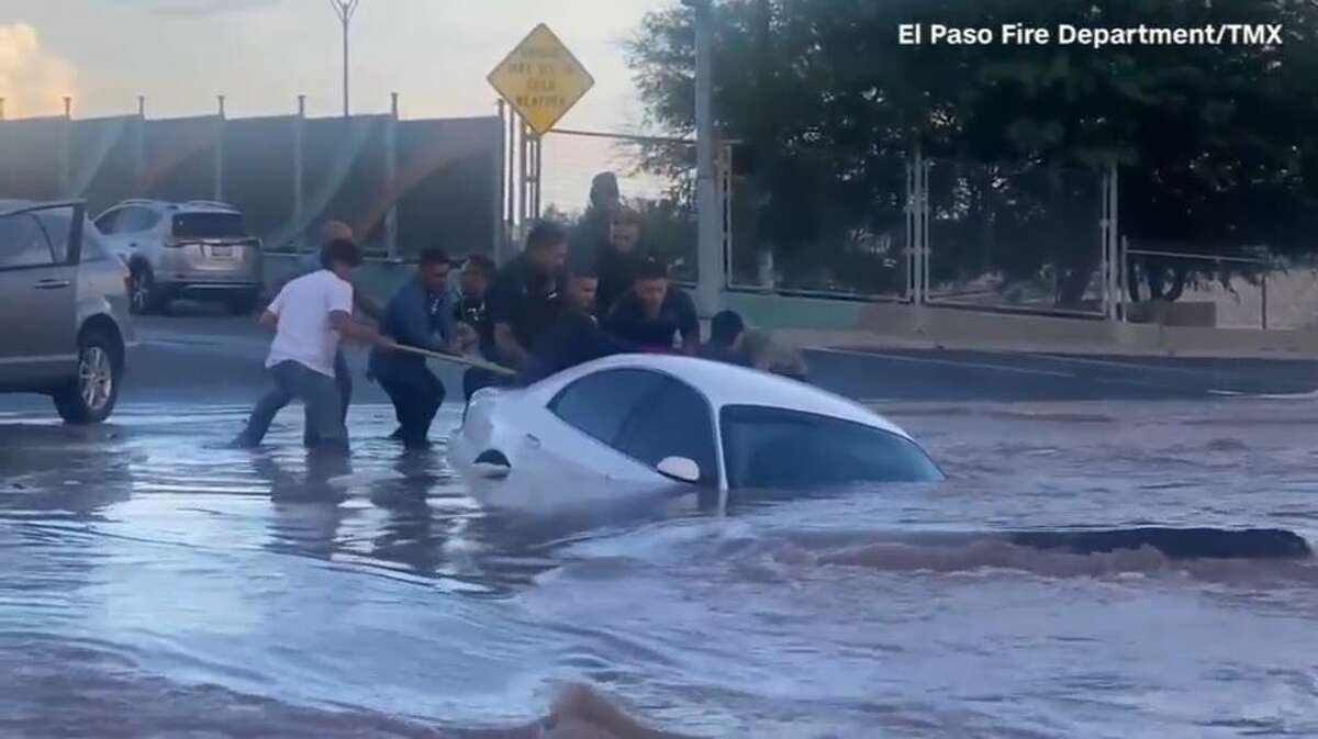 A woman from Texas was rescued through the rear windshield of her sinking car just moments before it was completely submerged in a water-filled sinkhole in El Paso.