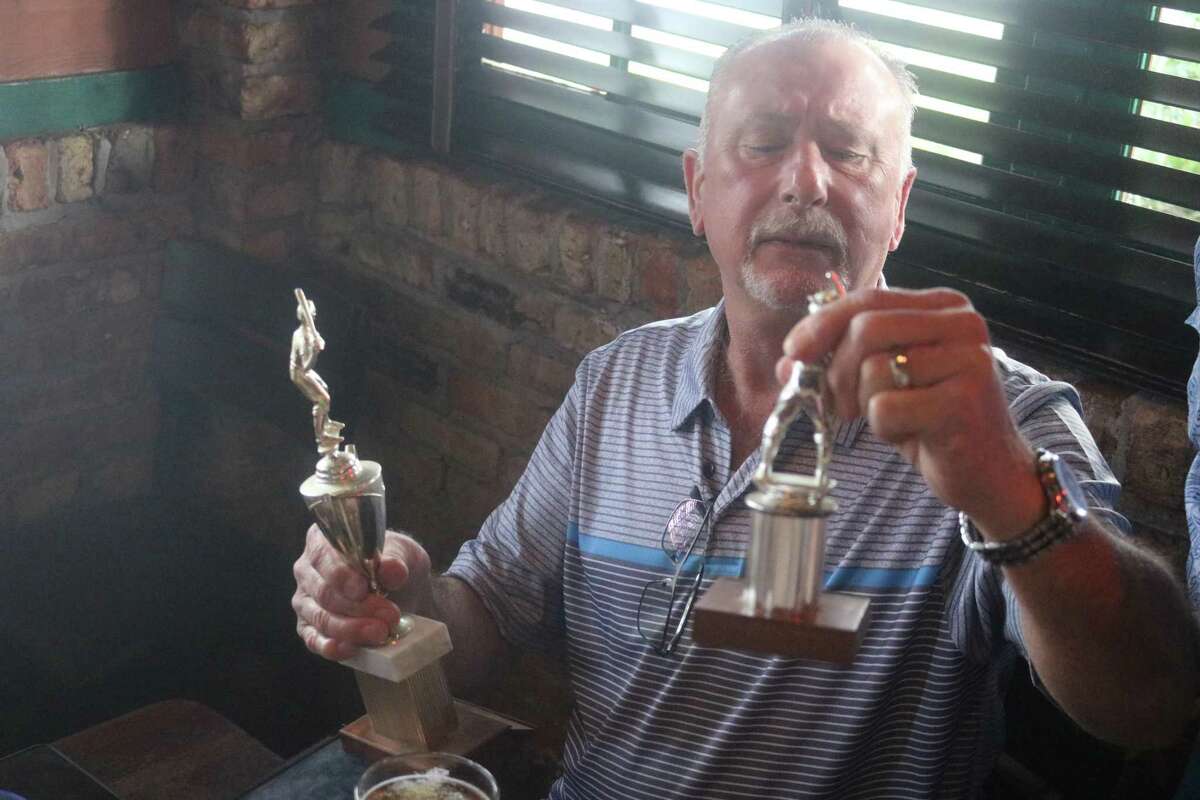Pan American Little League 1972 all-star Greg Emmerson examines two trophies from that amazing summer during last weekend's 50-year reunion of the state champions.
