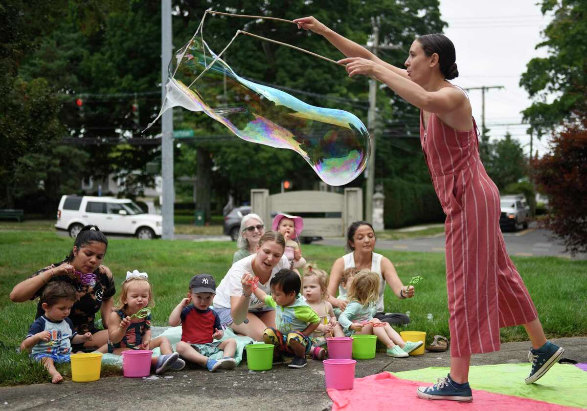 Polly Solomon, of Polaris Circus Arts, performs Bubble Extravaganza at Temple Sholom in Greenwich, Conn. Wednesday, Aug. 10, 2022. Full-day program and summer camp children watched, popped, and stomped bubbles big and small during the hands-on show.