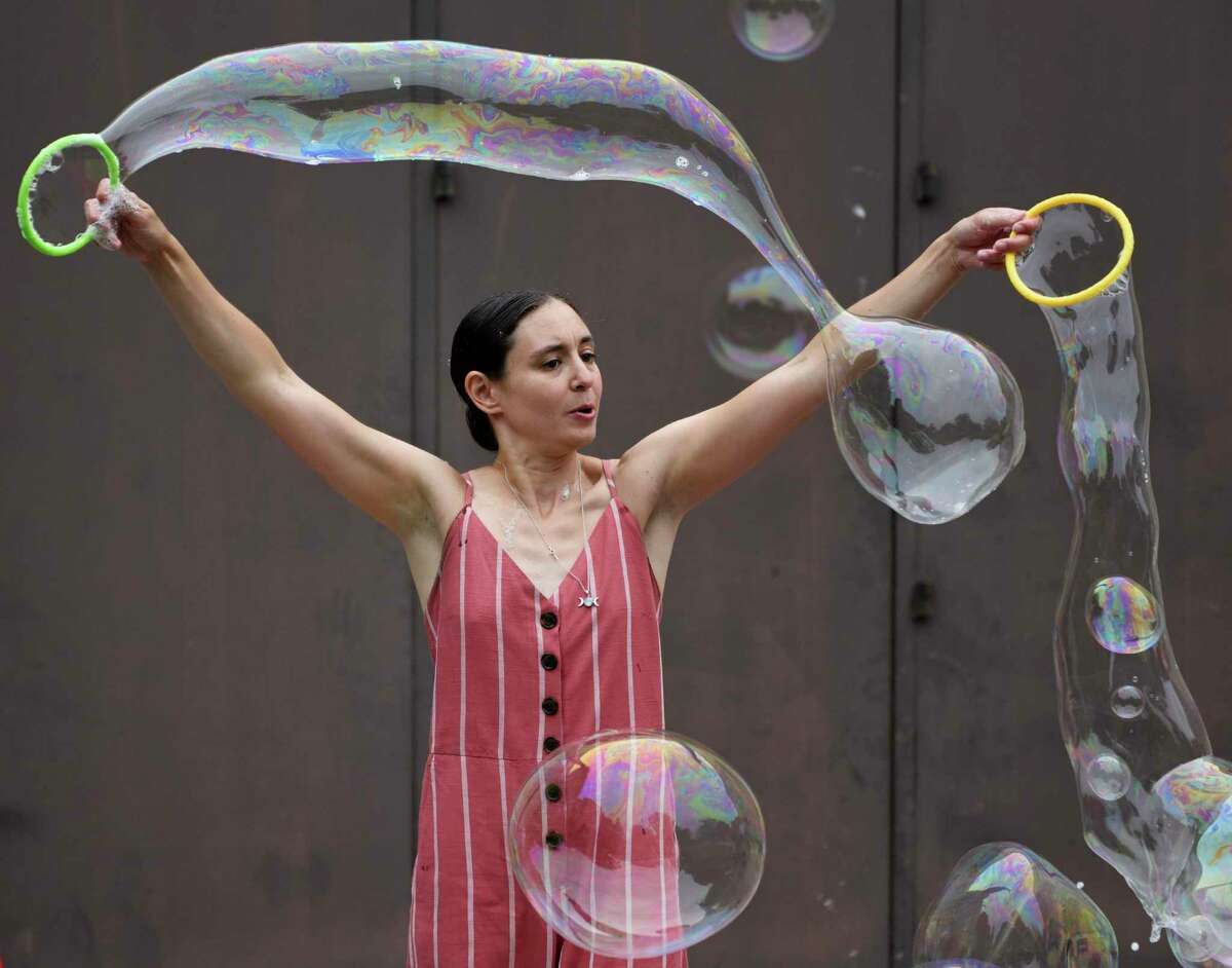 Polly Solomon, of Polaris Circus Arts, performs Bubble Extravaganza at Temple Sholom in Greenwich, Conn. Wednesday, Aug. 10, 2022. Full-day program and summer camp children watched, popped, and stomped bubbles big and small during the hands-on show.