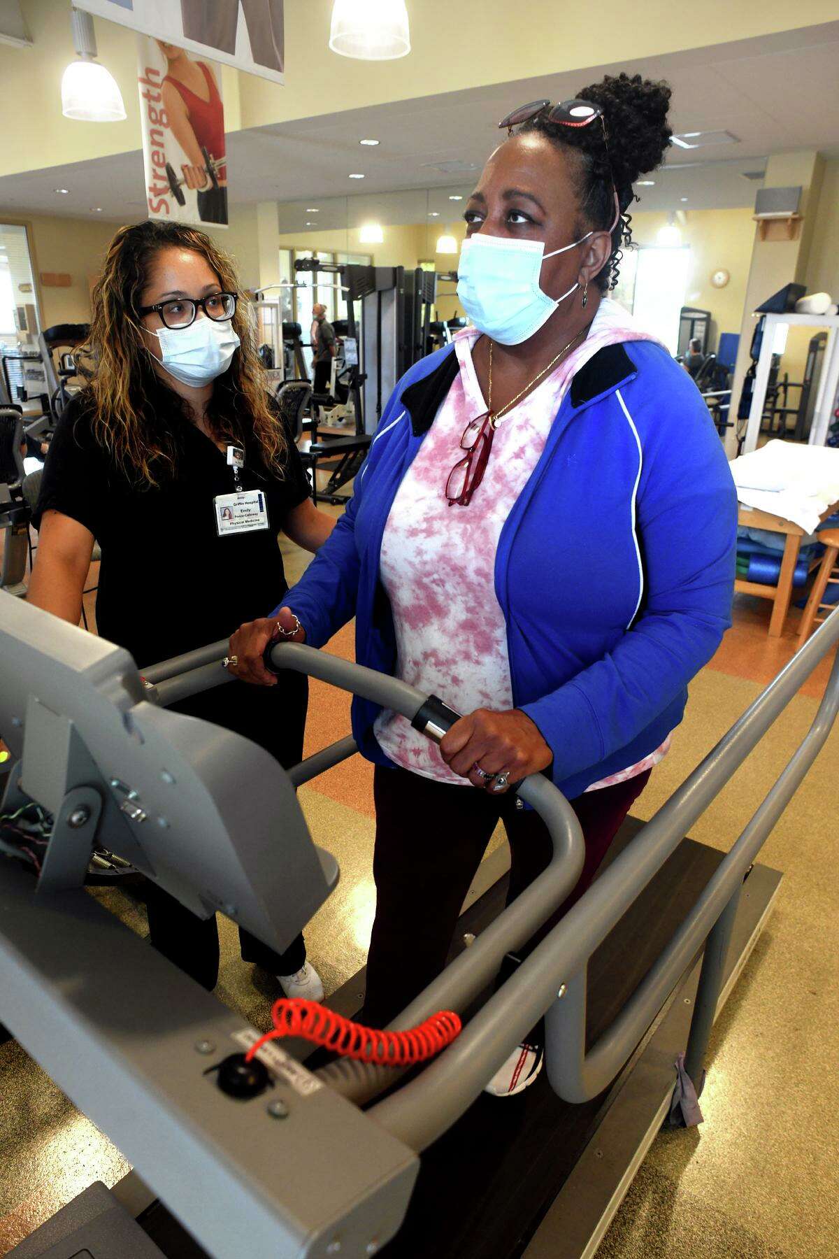 Pamela R. Lopes, of Woodbridge, a long term COVID patient, walks on a treadmill with physical therapist Emily Ponce-Calloway at Griffin Health’s physical therapy and rehabilitation facility in Derby, Conn. Aug. 10, 2022.