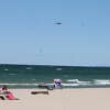 A U.S. Coast Guard helicopter flies over Lake Michigan at Fifth Avenue Beach in Manistee after a report was made of a capsized kayak in the water. It was later revealed the supposed kayak was actually a piece of dredging equipment near the pier.
