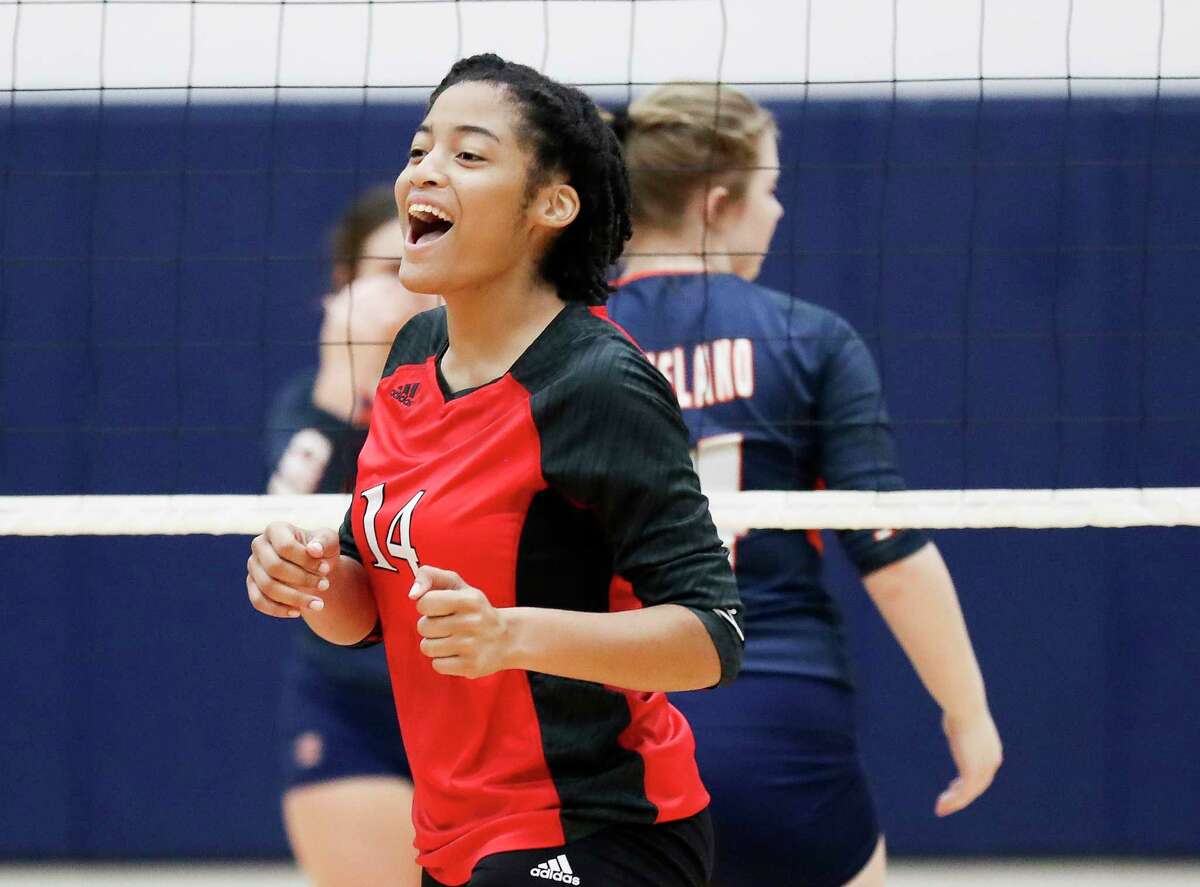 Aldine MacArthur's Natalie Gammage (14) celebrates after scoring a point in the first set of a non-district high school volleyball match during the Katy ISD/Cy-Fair ISD Volleyball Tournament, Thursday, Aug. 11, 2022, in Cypress.