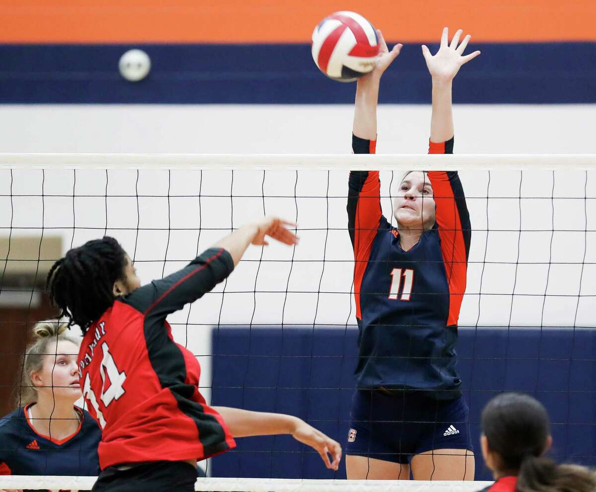 Bridgeland's Molly McClure (11) blocks a shot by Aldine MacArthur's Natalie Gammage (14) in the first set of a non-district high school volleyball match during the Katy ISD/Cy-Fair ISD Volleyball Tournament, Thursday, Aug. 11, 2022, in Cypress.