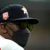 Houston Astros manager Dusty Baker Jr. wears a mask as he watches from the dugout during the second inning of a baseball game against the Texas Rangers Thursday, Aug. 11, 2022, in Houston. (AP Photo/David J. Phillip)