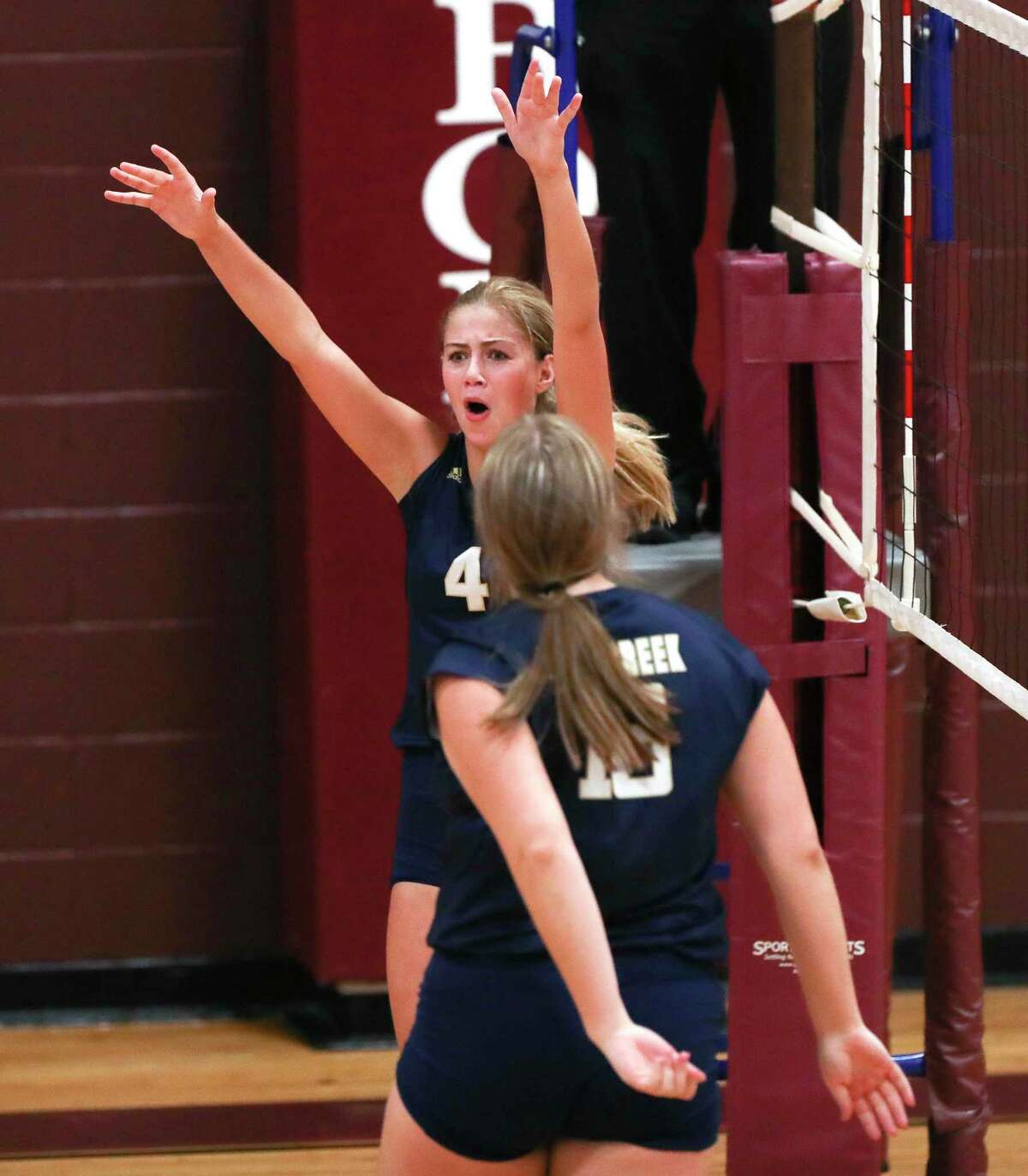 Lake Creek's Payton Woods (4) reacts after blocking a shot in the first set of a non-district high school volleyball match during the Katy ISD/Cy-Fair ISD Volleyball Tournament, Thursday, Aug. 11, 2022, in Cypress.