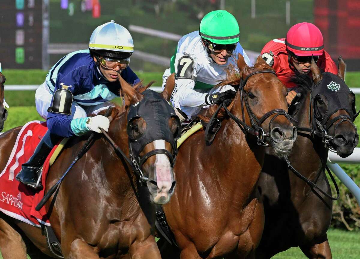 Poppy Flower, left, goes past Empress Tigress, center, and Delmona in the stretch run of the Galway at Saratoga Race Course on Thursday, Aug. 11, 2022.