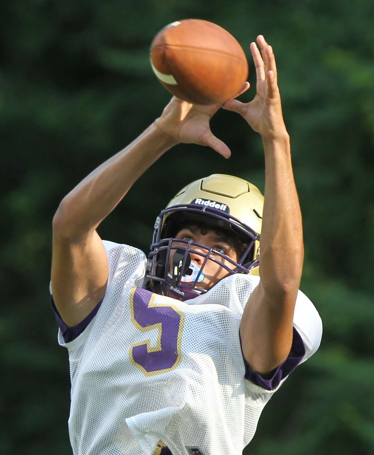 Routt's Michael Wilson looks the ball into his hands during football practice on Thursday in Jacksonville.