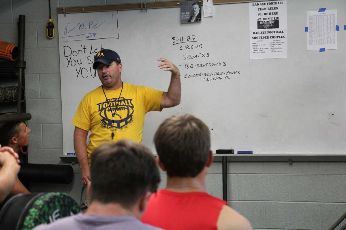 Bad Axe coach Steve VerBurg instructs his players on weight room training. VerBurg announced Wednesday he is stepping down from his position as Hatchets head coach after one season.