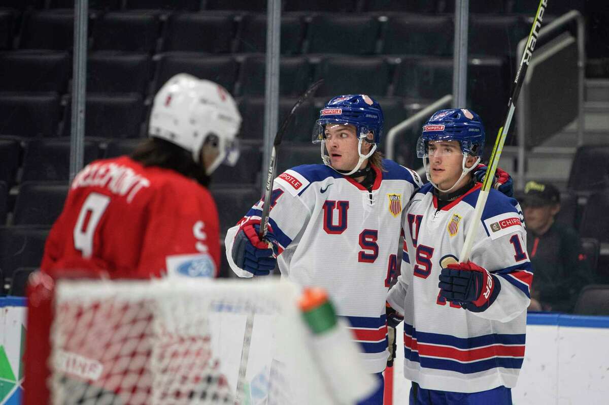 United States' Mackie Samoskevich, right, and Carter Mazur celebrate a goal against Switzerland during the second period of an IIHF world junior hockey championships game Thursday, Aug. 11, 2022, in Edmonton, Alberta. (Jason Franson/The Canadian Press via AP)