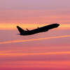 An aircraft silhouette during the magic hour of a departing passenger plane. 