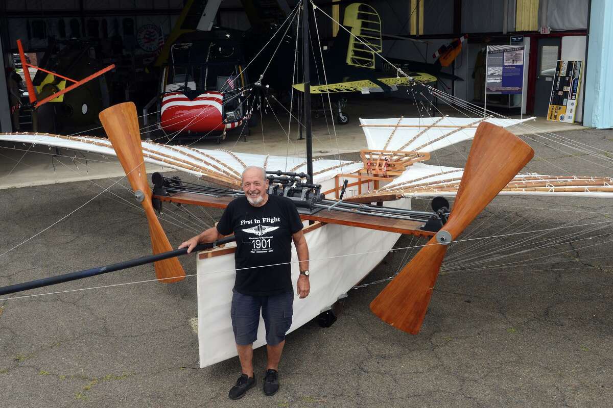 Andy Kosch stands next to his replica of Gustave Whitehead’s “No. 21” airplane, currently on display at the Connecticut Air and Space Museum, in Stratford, Conn. Aug. 3, 2021. The working replica, which Kosch flew in 1986, is a recreation of aviation pioneer Gustave Whitehead’s 1901 airplane, which some credit for being the first powered aircraft to take flight in.