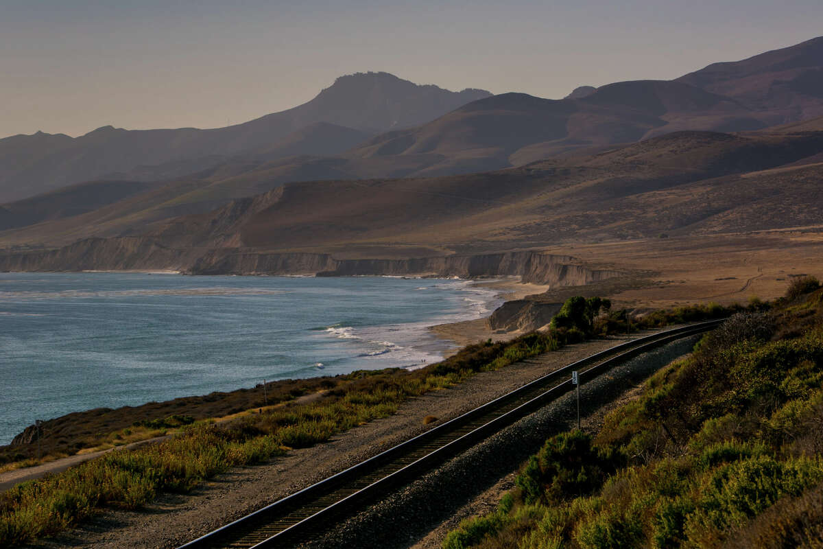 Amtrak train track hug the rugged California coastline near Jalama Beach, California. 