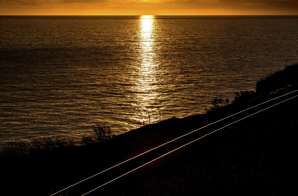 Sunset over the Pacific Ocean above the Amtrak train tracks in December 2018, at Gaviota State Beach.