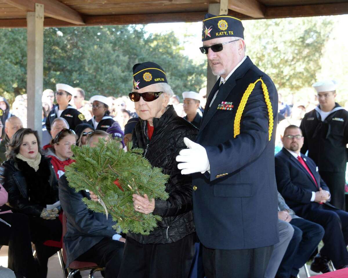 Thelma Williams, with the assistance of Jim McGuire, places a wreath in memory of those who served and are serving in the US Army during the National Wreaths Across America Ceremony at Magnolia Cemetery, Saturday, Dec. 15, 2018, in Katy, TX.