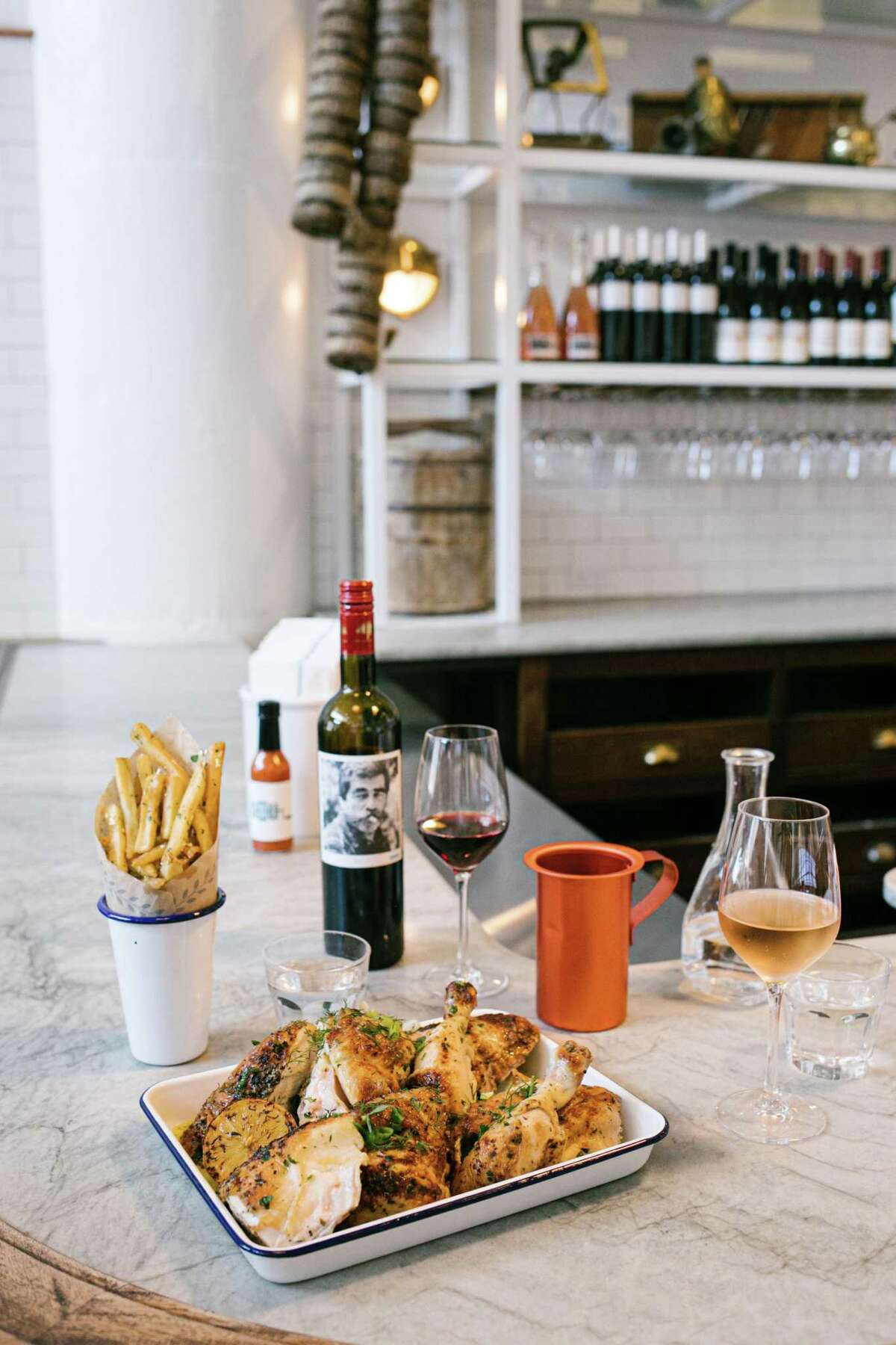Souvla's feta-brined rotisserie chicken has always been available for takeout. At the new Dogpatch location, it is also available for dinner. Pictured alongside is Souvla's private label Greek red wine.