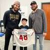 Ian Anderson, left, and brother Ben, right, posed for a photo with fan Micah Conklin during a visit to Impact Athletic Center in Halfmoon. (Courtesy of Bob Anderson)
