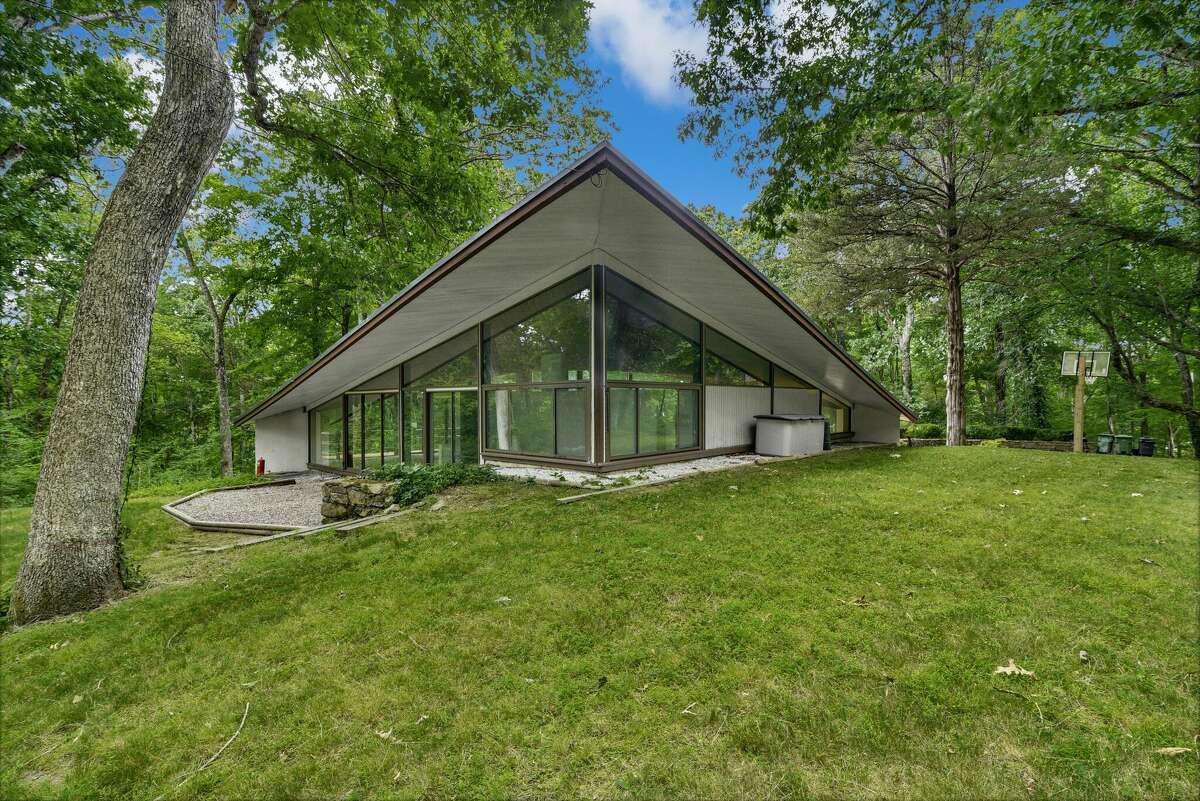 The home on 44 Benedict Hill Road in New Canaan, Conn. is designed in a mid-century modern style by architect James Evans, who was inspired by Philip Johnson's "Glass House."