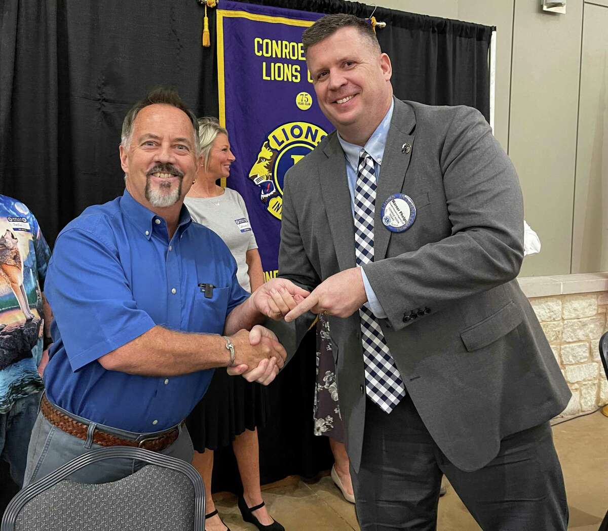 The Conroe Noon Lions Club President Warner Phelps, right, thanks Pastor Jeff Williams, left, for presenting a program last week about the Eagle’s Nest Ministries and their after program, which assist recently released felons assimilate back into society.