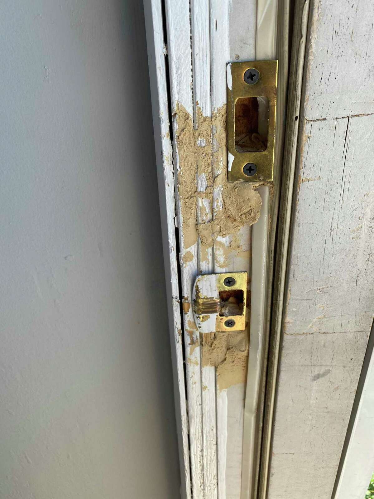 Maintenance workers used putty as a temporary fix in Donna Curry's door at Wedgewood Apartments but she said that her door doesn't close safely at night.