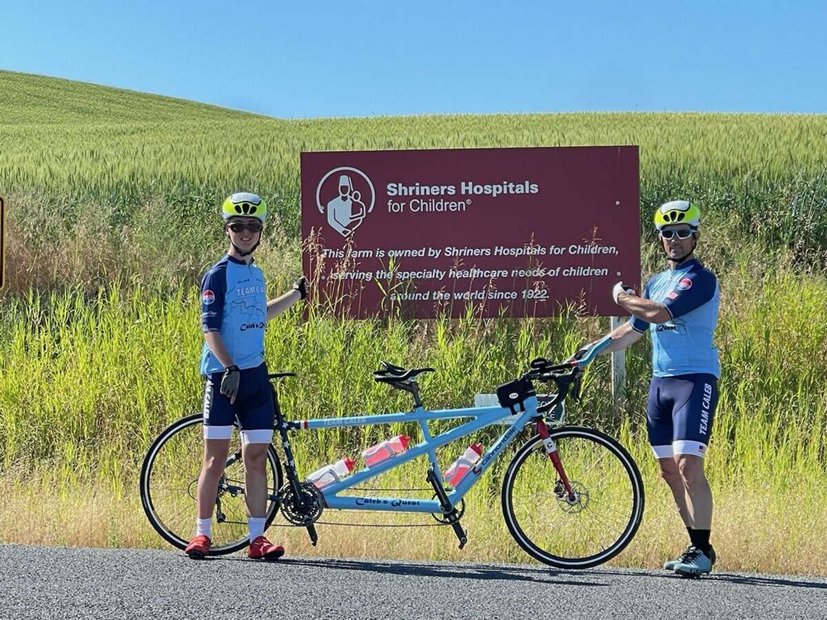 Caleb Schroeder (left) and his father, Kirk Schroeder, are tandem-riding across the country to raise money for Autism Speaks and Shriners Hospitals for Children. 