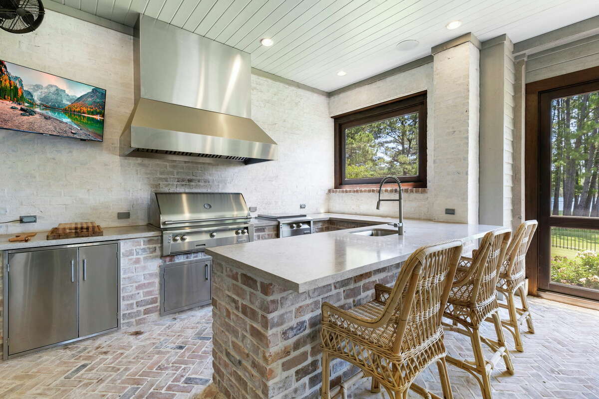 The outdoor kitchen located in the screened-in patio