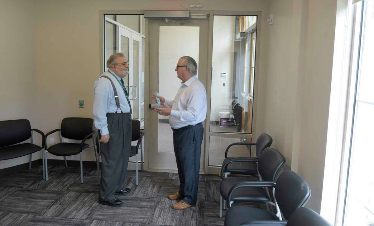 Richard Palanzo, director of facilities CIFC, left, and Joseph Walkovich, director of advancement, in a new reception area at the Connecticut Institute for Communities. The CIFC is opening a new 8,500 square-foot wing at 120 Main Street in Danbury. The new wing includes 3 new dental operatories, a new family medicine suite, 8+ additional pediatric and adult medicine exam rooms, and a Primary Care Simulation Laboratory for CIFC’s Teaching Health Center program. Thursday, August 11, 2022, Danbury, Conn.