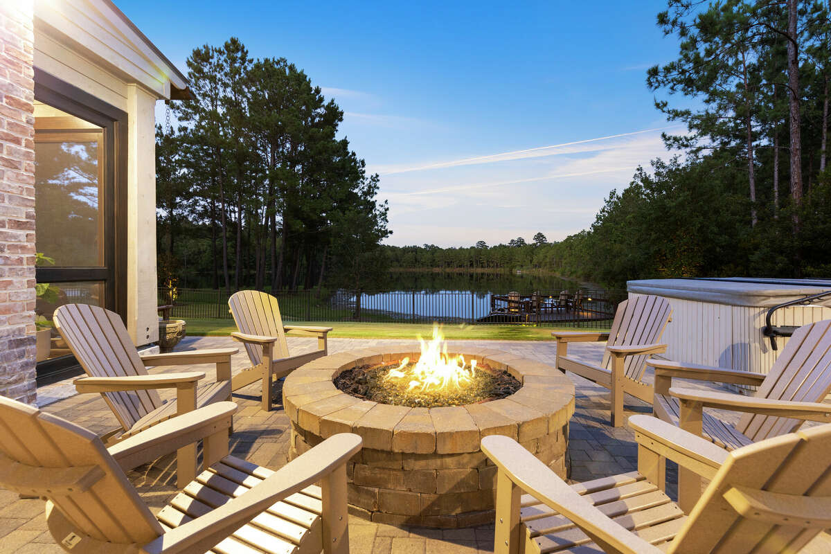 The fire pit is located next to the hot tub. 
