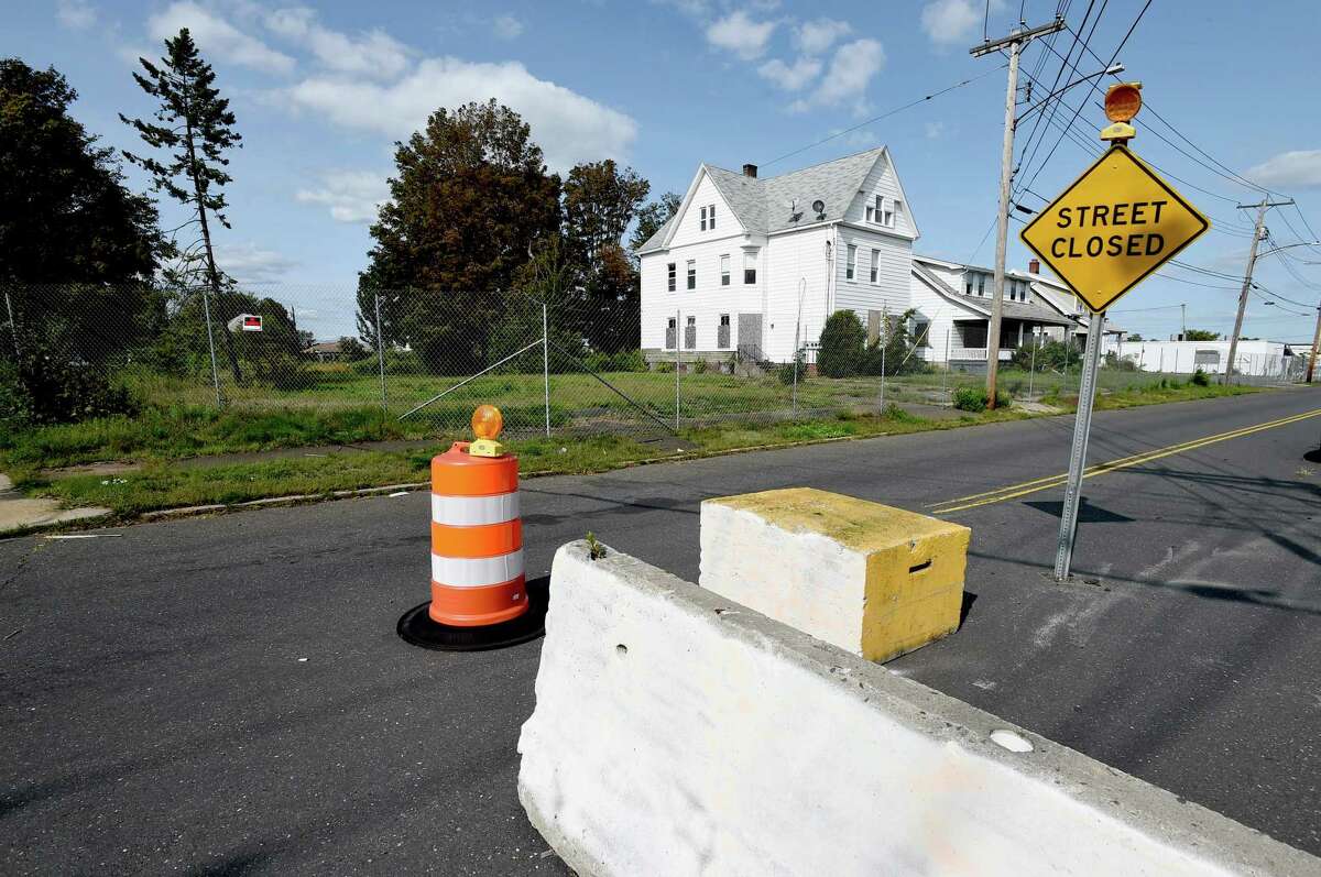 Boarded-up houses and closed streets in the fenced-off First Avenue neighborhood for a mall development project in West Haven, where agencies have conducted training exercises.