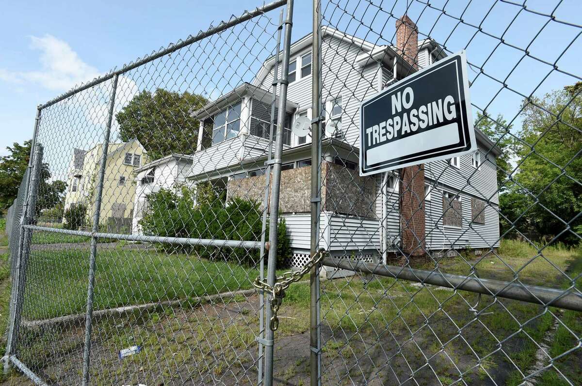 Boarded-up houses and closed streets in the fenced-off First Avenue neighborhood for a mall development project in West Haven, where agencies have conducted training exercises.