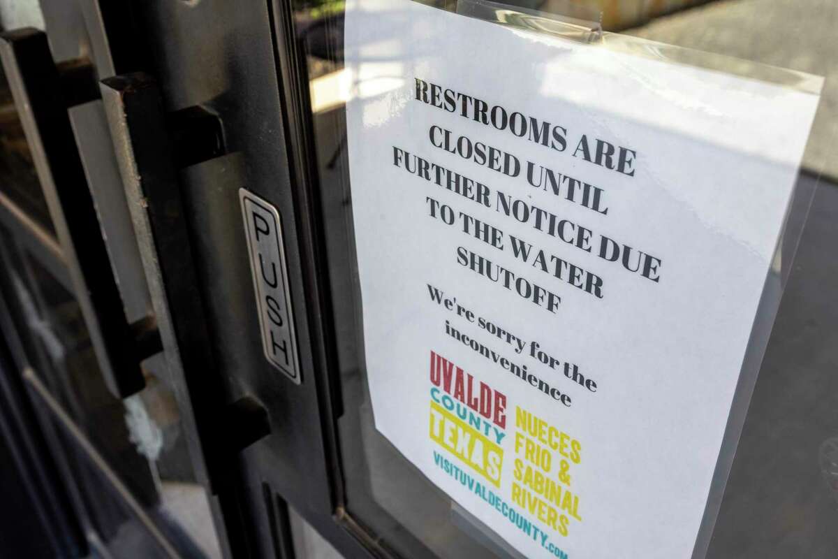 A sign on the Uvalde County Visitor Center building in Concan on Aug. 10 lets people know the restrooms in the building are closed due to water supply problems. The Concan Water Supply Corp. has been trucking water continuously from a still-producing well to public drinking water tank farms several miles away to keep water flowing to those parts of town.