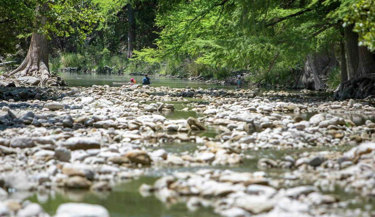 A trickle of water can be seen in the nearly dry Frio River on Aug. 10 at the Third Crossing near Concan. The official U.S. Geological Survey water gauge for the river in Concan reported a flow of 0 cubic feet per second on that day.