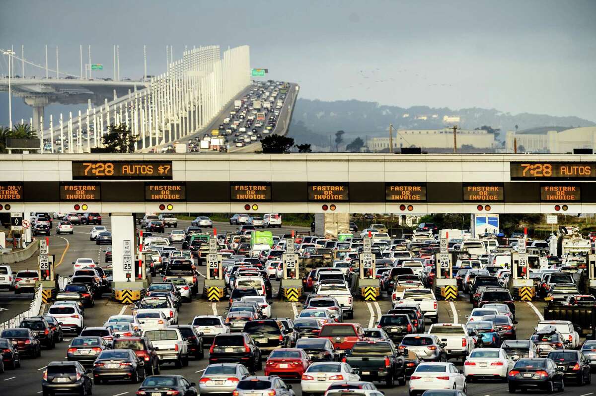 Cars and trucks approach the Bay Bridge toll plaza in Oakland.
