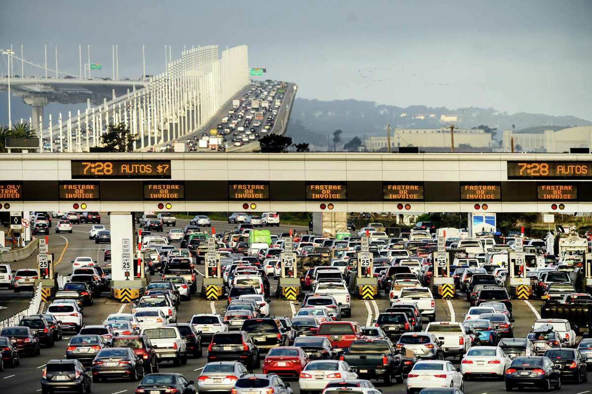 Cars and trucks approach the Bay Bridge toll plaza in Oakland, Calif.