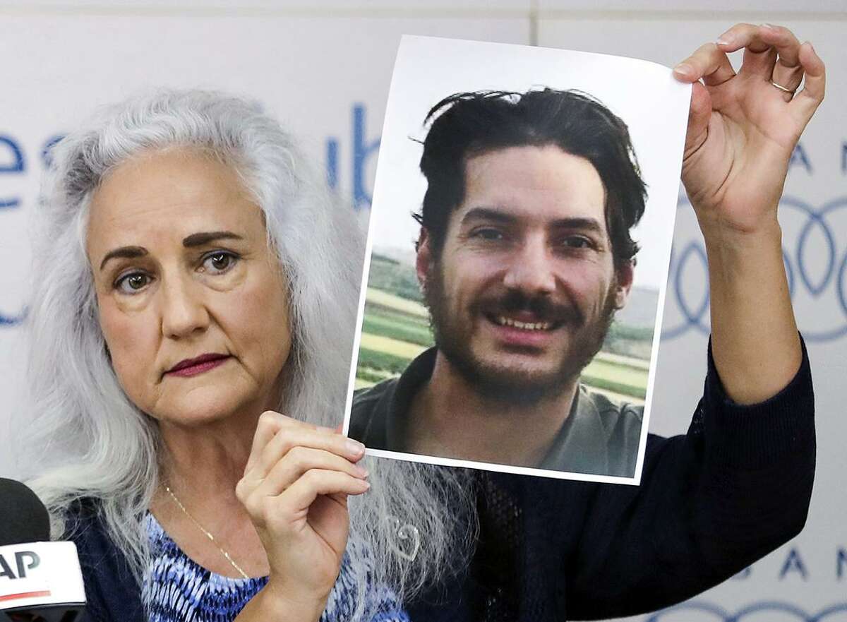 Debra Tice, mother of Houston journalist Austin Tice, who was kidnapped in Syria five years prior, holds a dated portrait of him during a press conference in the Lebanese capital Beirut on July 20, 2017.