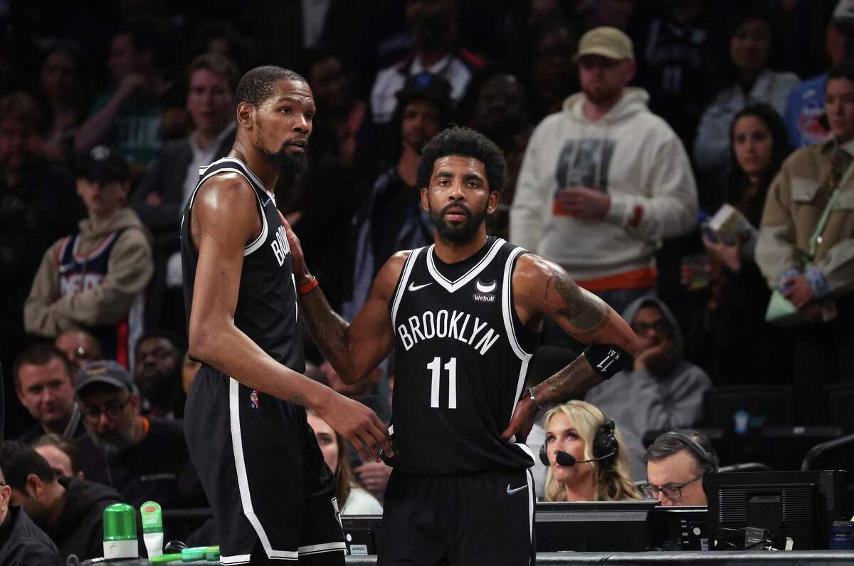 The Brooklyn Nets' Kevin Durant, left, and Kyrie Irving (11) look on in the final seconds of a 109-103 loss against the Boston Celtics during Game 3 of the Eastern Conference first-round playoff series at Barclays Center on Saturday, April 23, 2022, in New York. (Al Bello/Getty Images/TNS)