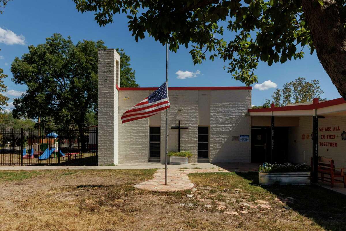 An American Flag flies at half-mast outside of Sacred Heart Catholic School in Uvalde, Texas, Wednesday, Aug. 10, 2022. The private school, which serves pre-kindergarten through sixth-grade students, will start the 2022-2023 academic year on Monday, Aug. 15, 2022.