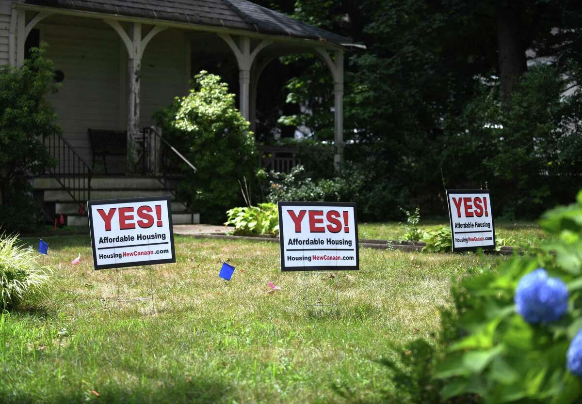 Yard signs in July 2022 promoting affordable housing in New Canaan, Conn. With Oregon three years into a new law capping rent increases in any given year, a Connecticut lawmaker is vowing to revisit the topic in next year’s Connecticut General Assembly session.