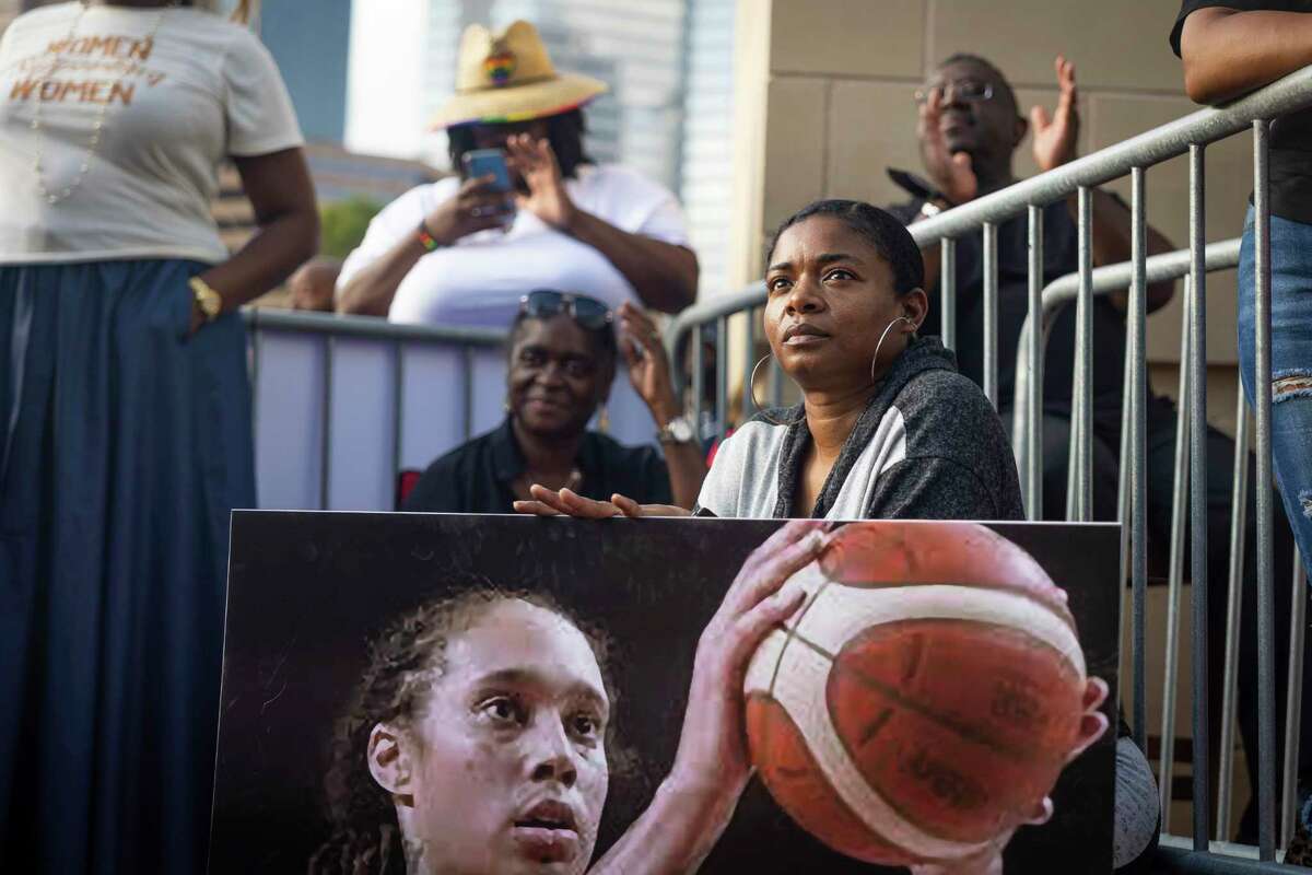 People listen to speakers during a rally to raise awareness for Brittney Griner outside of the Toyota Center on Sunday, June 6, 2022.