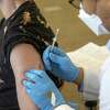 A health worker administers a dose of the Bavarian Nordic Jynneos monkeypox vaccine at a vaccination site in West Hollywood, Calif., on Aug. 3.